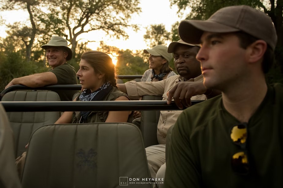 The family and their guide setting out on an early morning game drive