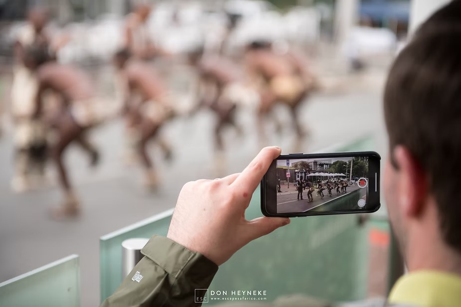Filming a traditional dance performance on a phone