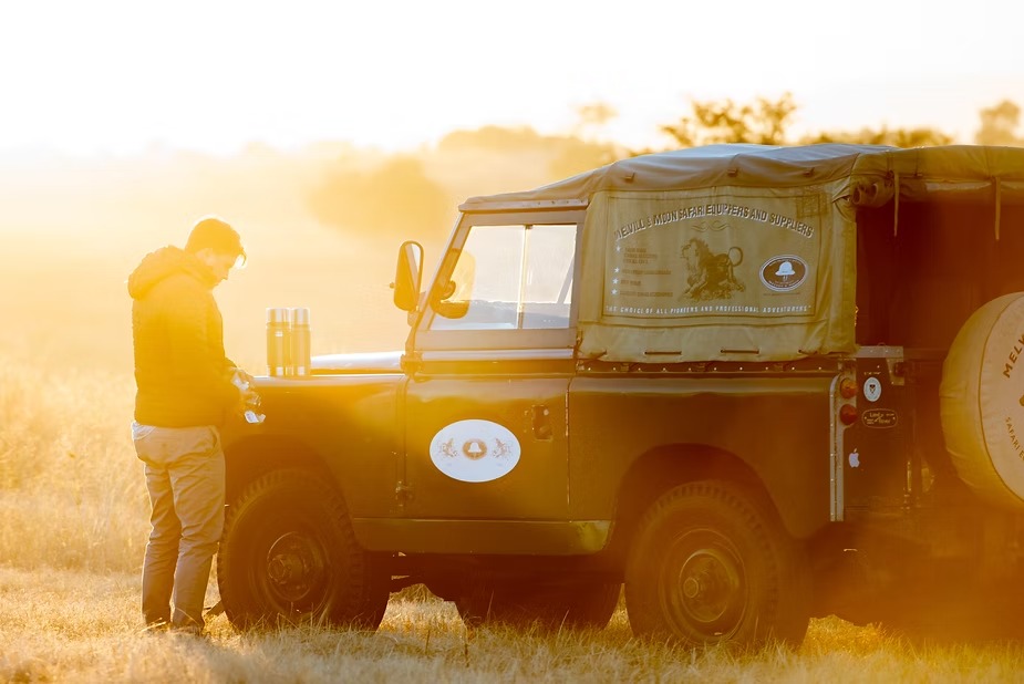 Loading a canvas-kitted Land Rover Defender in early morning light