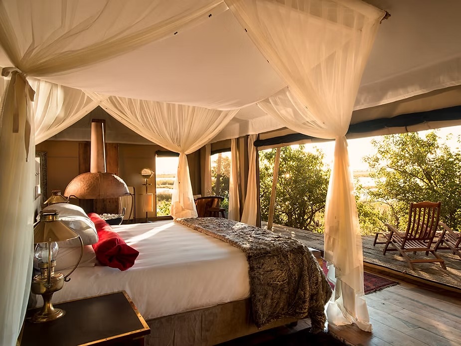The canopied bed and fireplace inside the Zarafa Dhow Suite