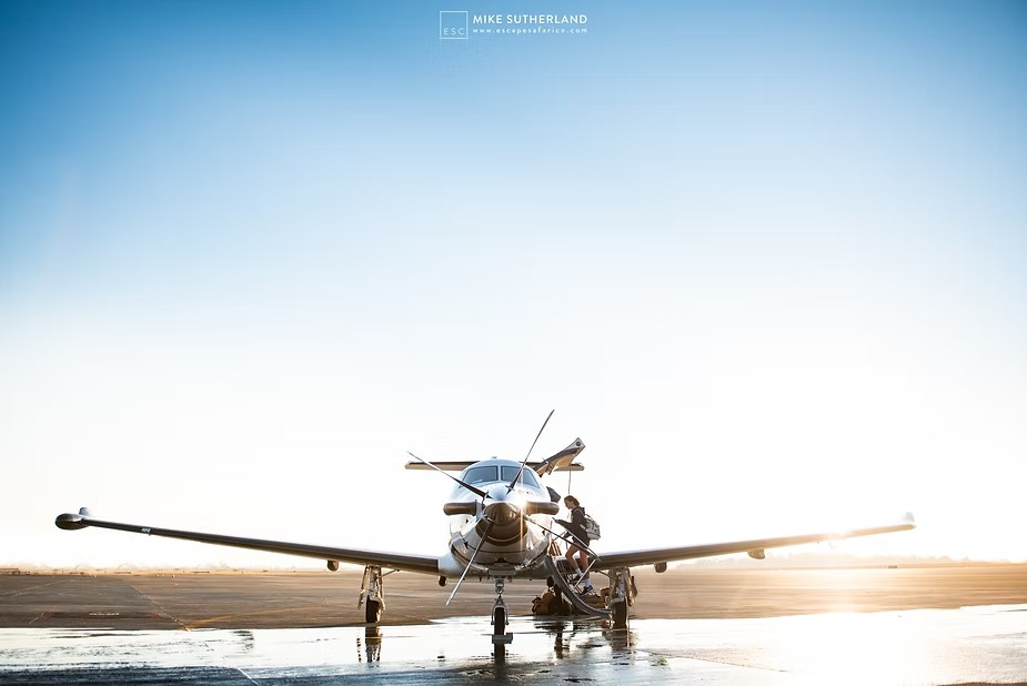 A light aircraft waiting on a bush airstrip at first light