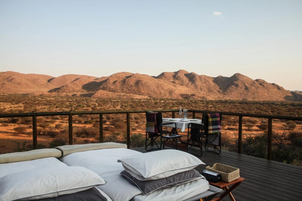 A Tswalu star bed on its open deck facing the red Kalahari hills at dawn