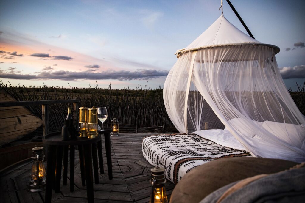 A canopied bed and lanterns laid out for the night at Nay Palad Bird Nest