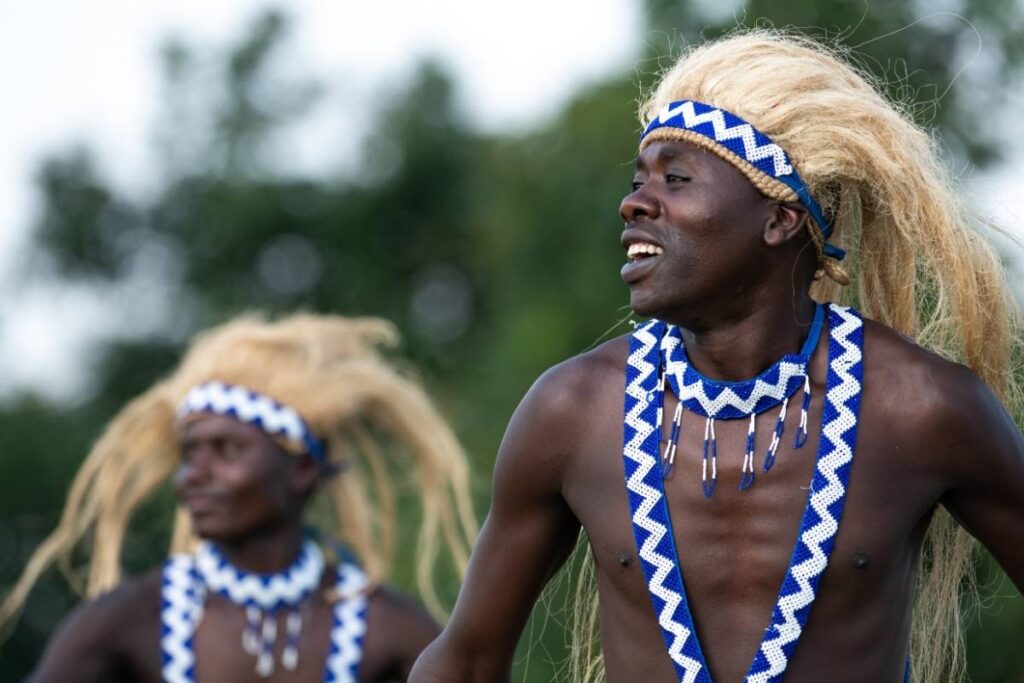 Intore dancers in traditional blond-fibre headdresses performing at Rwanda's Kwita Izina gorilla naming ceremony